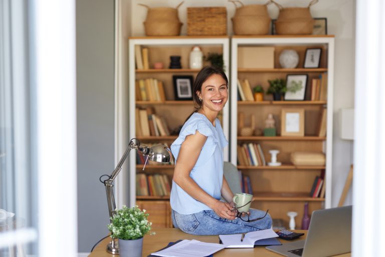 Young businesswoman smiling while working from her home office